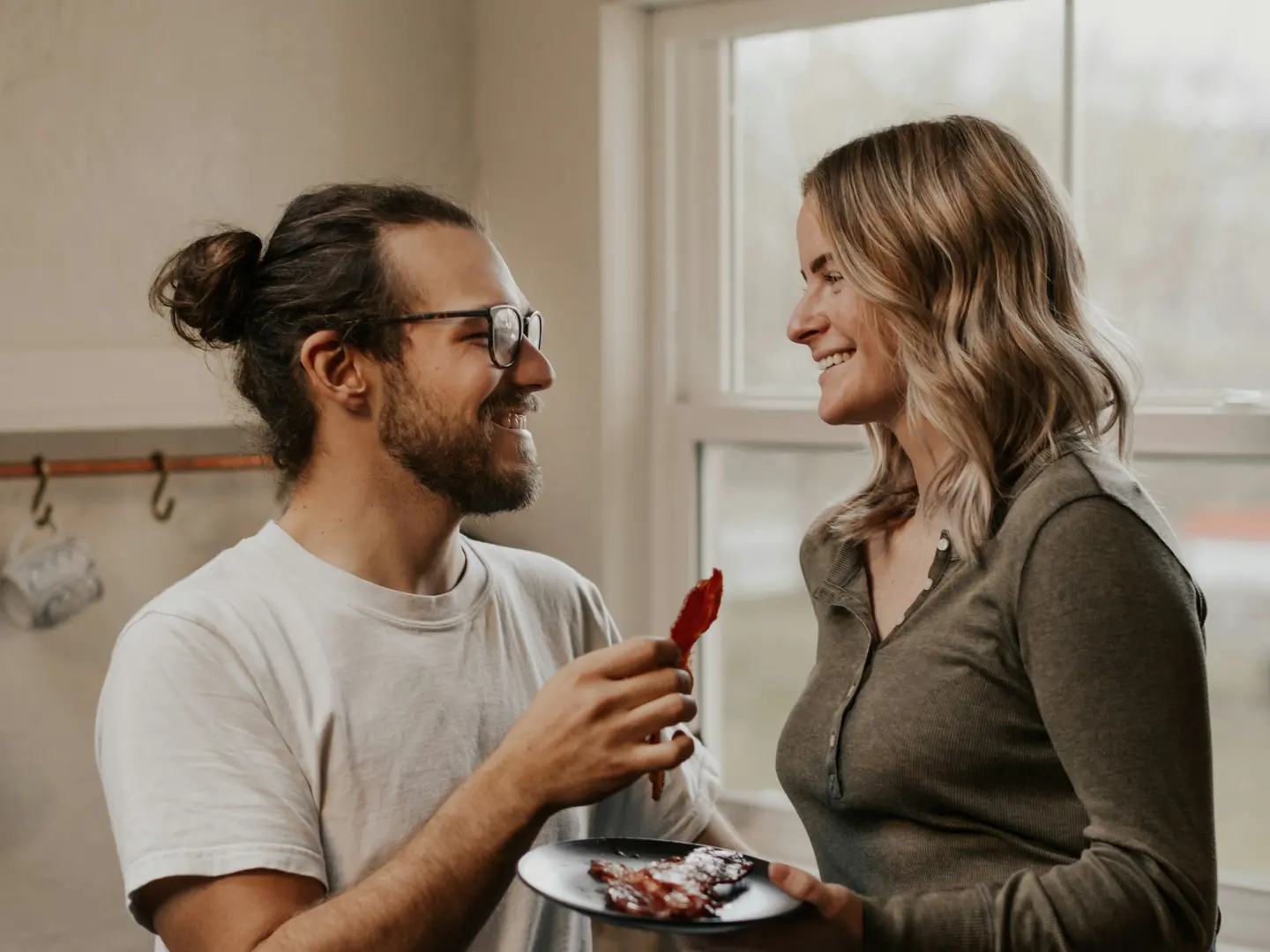 A couple talking together in a kitchen